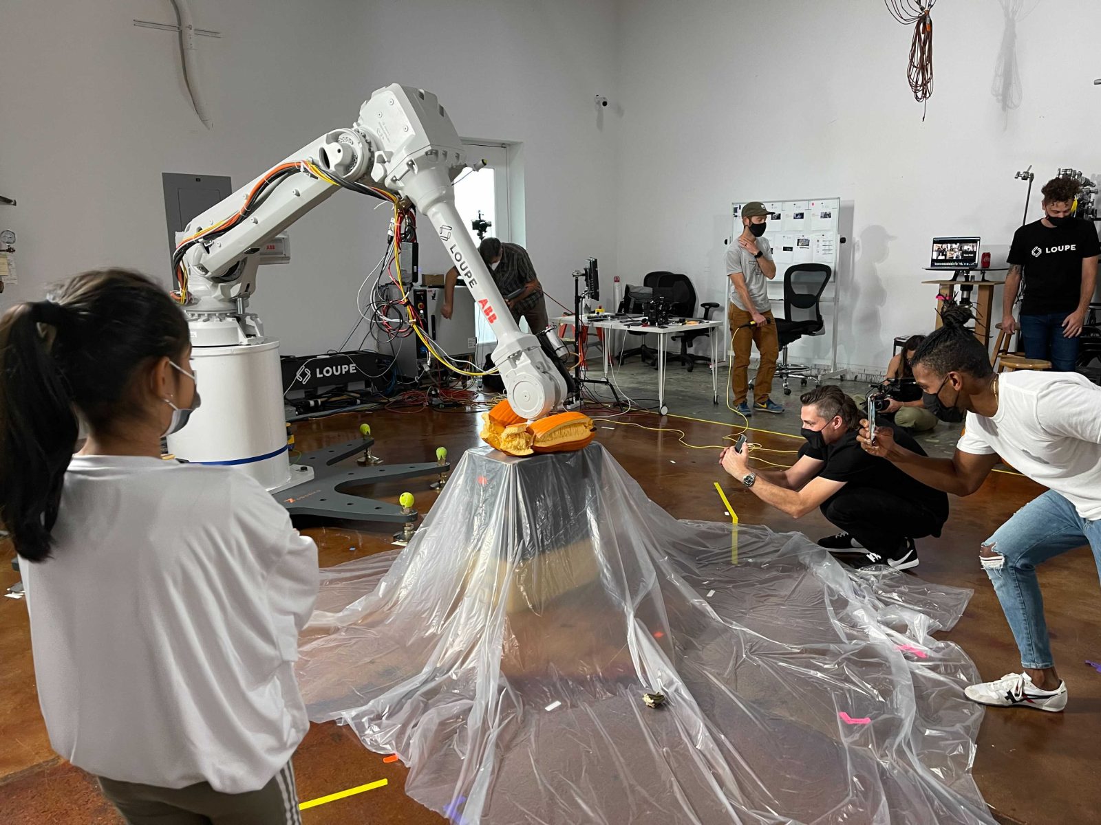 Student observing an industrial robot arm